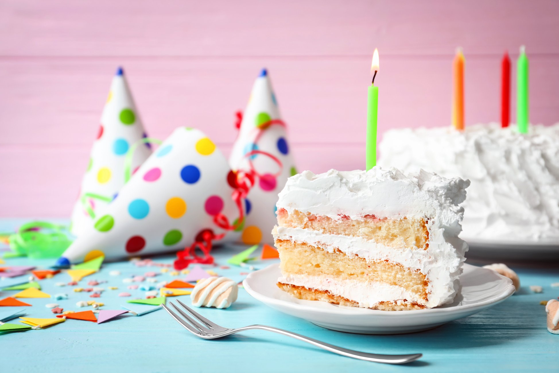 Piece of Birthday Cake with Candle on Table