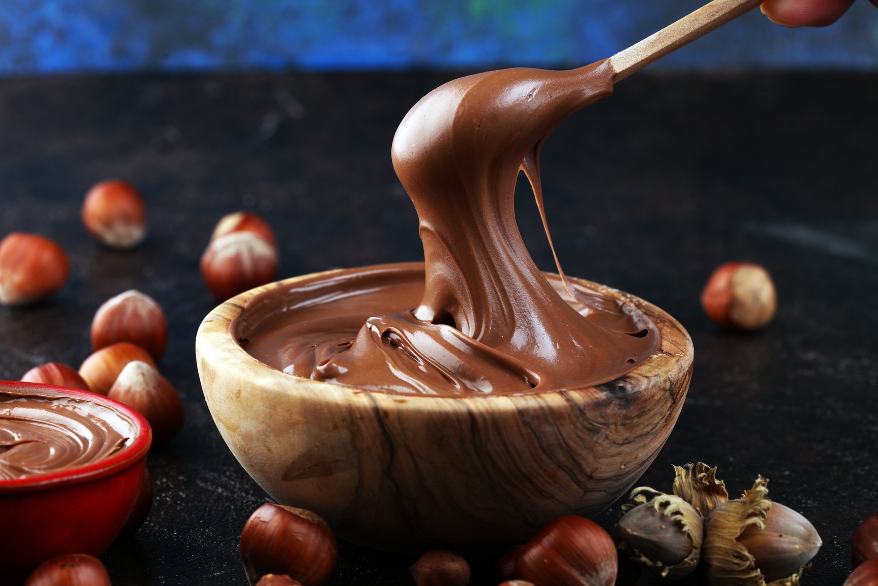 Homemade hazelnut spread in wooden bowl. Hazelnut Nougat cream with hazelnuts